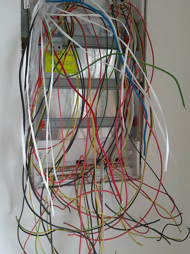 Old switchboard opened up with loose cables mid rewire