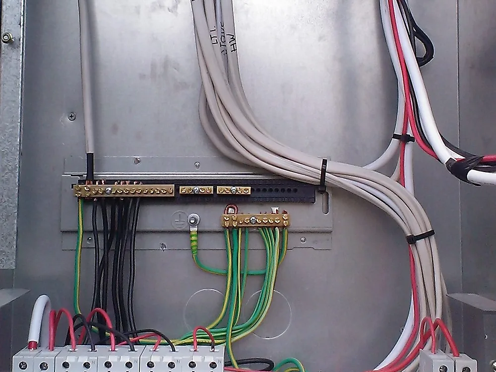 Sub board in a steel enclosure with breakers, earth bar and cables neatly routed